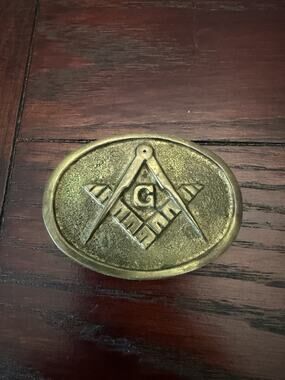 This is a vintage brass Masonic belt buckle.